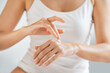 © Rido - Close up of woman applying lotion on hands