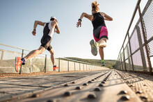 Triathlon Runners Compete On A Bridge In Wide Angle Image