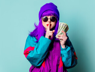 Canvas Print - Stylish white girl with purple hair and 80s tracksuit hold cash money on blue background