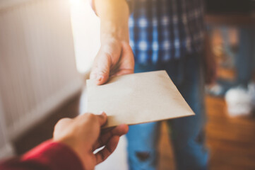 The young man is picking up the parcel from the guy. Concepts of parcel delivery.