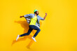 © deagreez - Full size profile side photo of brunette dark skin man jump up run empty space sale isolated on yellow color background