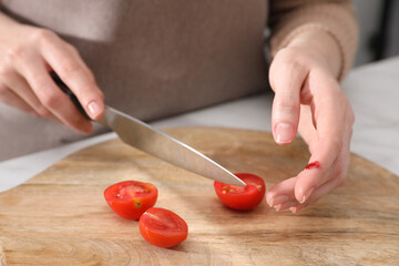 Poster - Woman cut finger while cooking in kitchen, closeup