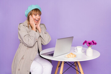 Poster - Photo of lady sit table look laptop palms cheeks wear blue beret scarf coat isolated violet color background