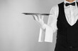© New Africa - Butler with tray on light grey background, closeup. Space for text