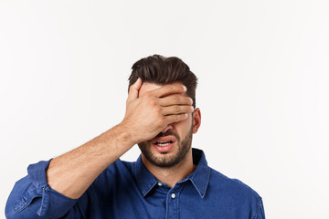 Wall Mural - Close up portrait of disappointed stressed bearded young man in shirt closing eyes over white background.