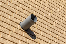 Plastic Pipe On The Side Of A Brick Wall