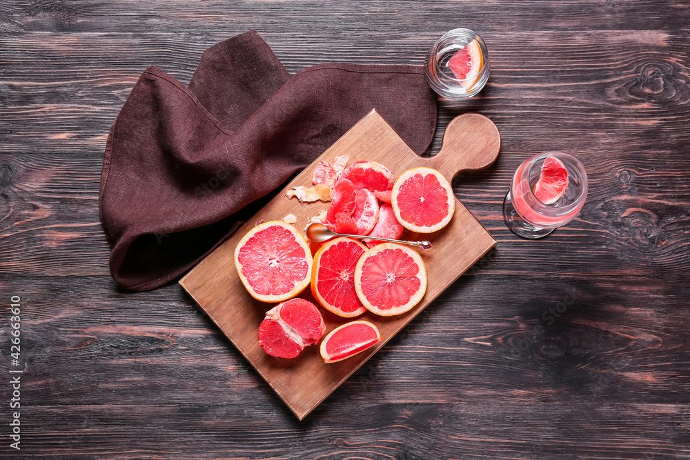 Composition with slices of ripe grapefruits on wooden background