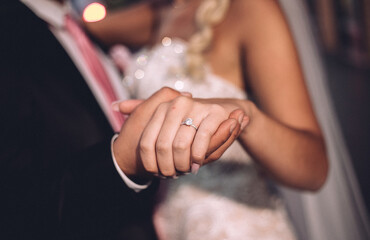 Sticker - Closeup shot of a newly married couple holding hands for a dance