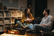 © cherryandbees - romantic couple listening to a music on record player at home