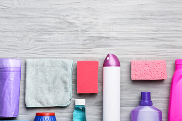 Set of cleaning supplies on wooden background