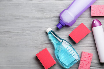 Set of cleaning supplies on wooden background