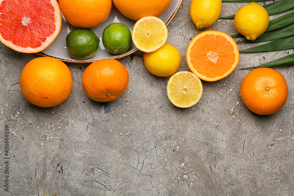 Fresh citrus fruits on grey background
