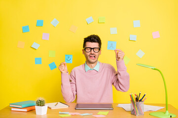 Sticker - Photo of young unhappy sad crying upset man in glasses showing sad and happy paper emoji isolated on yellow color background