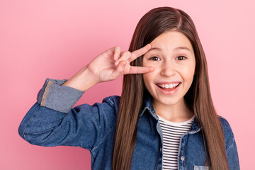 Sticker - Photo portrait of little girl showing v-sign gesture smiling overjoyed isolated on pastel pink color background