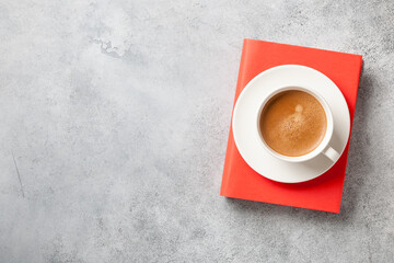 Canvas Print - Book and cup of coffee on concrete surface