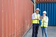© BritCats Studio - Caucasian men and women freight  supervisor wearing safety vest and hat while inspect condition of all containers shipment with tabket, People and worker in freight deliver, import and export.