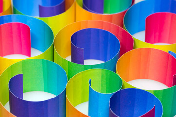 Wall Mural - Rolled colorful paper strips on white background