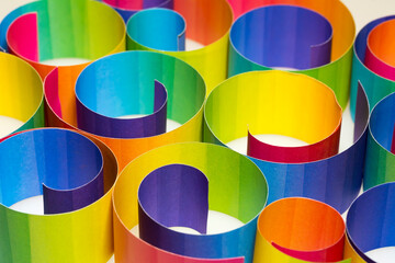 Wall Mural - Rolled colorful paper strips on white background