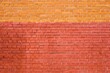 solid texture of an empty brick wall of two shades of red and yellow for background and wallpaper