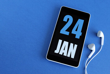 January 24. 24 st day of the month, calendar date. Smartphone and white headphones on a blue background. Place for your text. Winter month, day of the year concept.