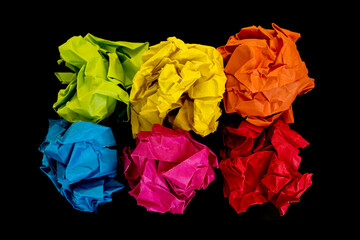 Wall Mural -  Crumpled color paper balls on black background