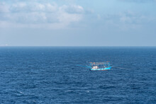 Small, Blue Fishing Boat At Open Sea.