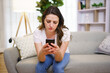 © Louis-Paul Photo - A Young woman sending text message with smartphone