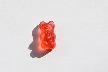 Red Gummy Bear Jelly Candy On White Background. Top View, Copy Space
