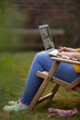 © Martin Barraud/Caia Image - Woman using laptop in garden lawn chair