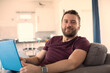 © Sam Edwards/Caia Image - Portrait confident man working from home at laptop