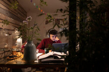 Focused Young Man In Headphones Working Late At Laptop In Home Office