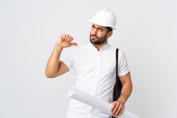 Canvas Print - Young architect man with helmet and holding blueprints isolated on white background proud and self-satisfied