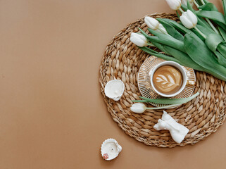 Wall Mural - Coffee cup and bouquet of white tulips . Concept of holiday, birthday, Women Day. Romantic Feminine flat lay. Good morning. still life.