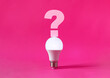 © kargona - Glowing light bulb with question mark on top of it on magenta background. Question, searching for ideas concept.