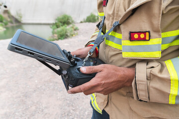 firefighter operating drone in search and rescue.