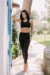 © shevtsovy - attractive fitness Female in sportswear outdoors. Sexy Female runner in sportswear exercising morning routine. Slim athletic woman run workout.