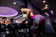© shevtsovy - athletic woman weightlifting dumbbells workout in gym. Cheerful strong woman barbell lifting indoors. Beautiful fitness model weight loss exercising.