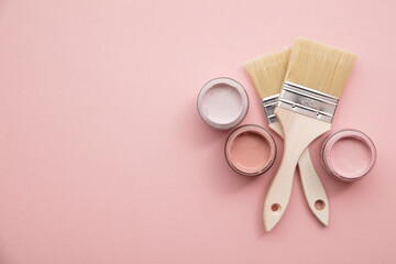 Wall Mural - Overhead view of a DIY paint brush with pastel pink sample paint pots