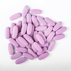 Purple pills on a white background. Global health care concept. Antibiotics drug resistance.