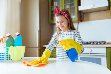 Cleaning the room, cleaning. Child girl washes and cleans the house of viruses and coronavirus. Cleanliness and order