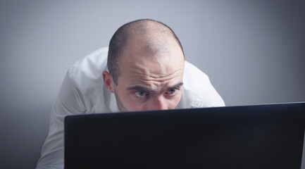 Wall Mural - Caucasian man working with laptop.