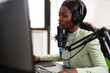 © DC Studio - Competitive esport streamer talking into microphone with teammates during live competition Streaming viral video games for fun using headphones and keyboard for online championship.
