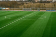 © Anastasia - Open empty football field. Green grass. Cloudy day.