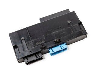 Poster - Plastic electronic control unit with black and blue connectors on a white isolated background in a photo studio. Spare part for sale or repair of car electronics in a car service.