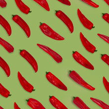 Abstract Seamless Pattern Of Fresh Red Long Sweet Pointed Peppers On Color Background.