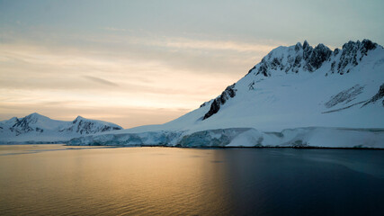 Wall Mural - Snow covered Mountains and Icebergs in the Antarctic Peninsula on Antarctica.