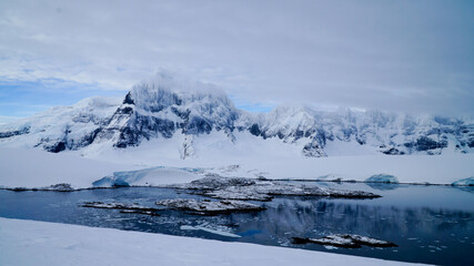 Wall Mural - Snow covered Mountains and Icebergs in the Antarctic Peninsula on Antarctica.