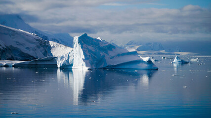 Wall Mural - Snow covered Mountains and Icebergs in the Antarctic Peninsula on Antarctica.