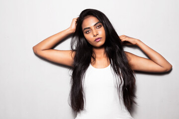 Asian Face of the beautiful woman with long black hair posing, hair, brown eyes wearing a white top