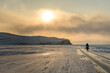 Byciclist on Baikal lake in winter on the sunset. Irkutsk Region, Russia